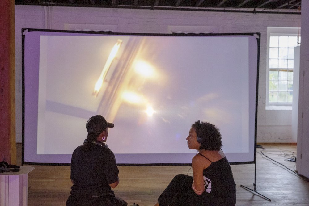 AVC Fest installation: visitors approaching the glass cabinet